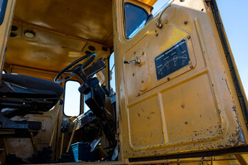 Closeup of a yellow tractor with russian instructions for using the levers