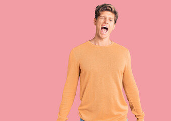 Young handsome man wearing casual clothes winking looking at the camera with sexy expression,...