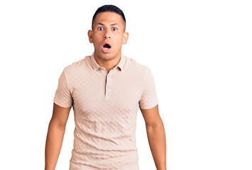 Young handsome latin man wearing casual clothes scared and amazed with open mouth for surprise, disbelief face