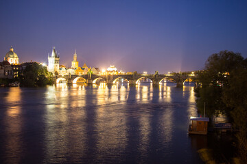 Pargue charles bridge by night reflections river moving lights