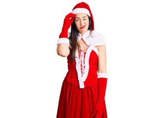 Obraz premium Young beautiful caucasian woman wearing santa claus costume worried and stressed about a problem with hand on forehead, nervous and anxious for crisis
