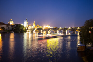 Pargue charles bridge by night reflections river moving lights