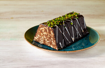 Chocolate mosaic cake on blue porcelain plate