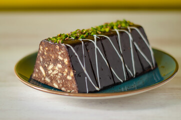 Chocolate mosaic cake on blue porcelain plate