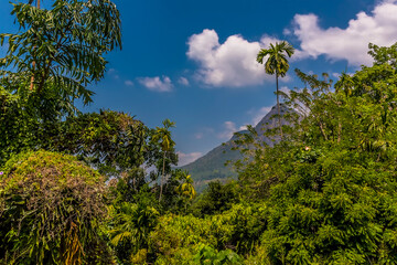 A glimpse of mountains from a train after leaving the station at Gangoda on the Kandy to Columbo main line railway in Sri Lanka, Asia