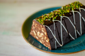 Chocolate mosaic cake on blue porcelain plate