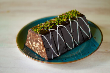 Chocolate mosaic cake on blue porcelain plate