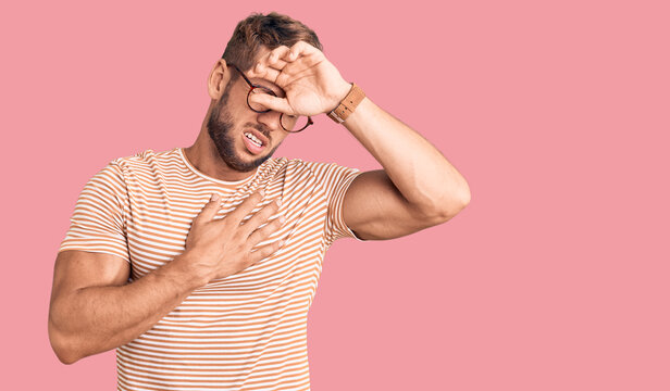 Young caucasian man wearing casual clothes and glasses touching forehead for illness and fever, flu and cold, virus sick