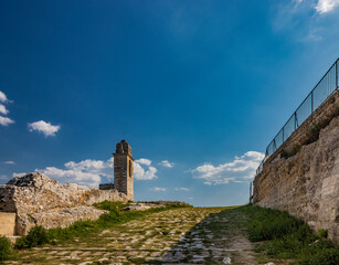 Gravina in Puglia, Italy. The path of pebbles and stones that leads to the Sanctuary of Madonna della Stella, with its bell tower and the ancient cave church carved into the rock.