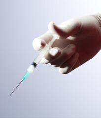 syringe in doctor's hand, white background