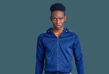 Young african american man wearing sportswear depressed and worry for distress, crying angry and afraid. sad expression.