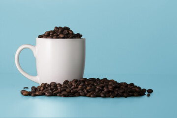 Blank white cup full of coffee beans. White mockup