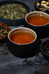 tea assortment. black, floral and herbal drinks on wooden table, vertical closeup