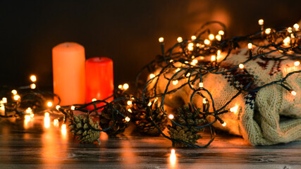 christmas candles on wooden background with sweater 