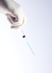 syringe in doctor's hand, white background