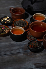 tea tasting different varieties. wooden background, vertical