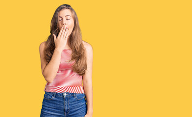 Beautiful caucasian young woman wearing casual clothes bored yawning tired covering mouth with hand. restless and sleepiness.