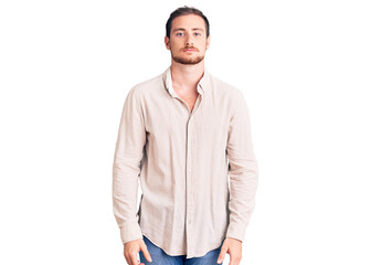 Fototapeta premium Young handsome caucasian man wearing casual clothes relaxed with serious expression on face. simple and natural looking at the camera.