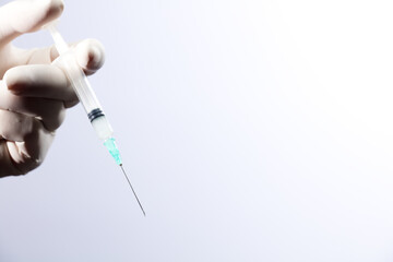 Doctor or nurse holding flu vaccine, syringe for measles injection prepares for baby and adult...