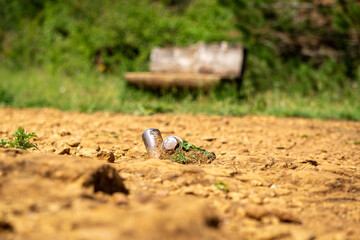 bolts on the ground and bench in the background
