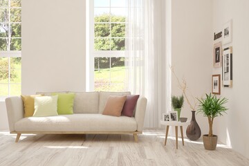 White living room with sofa and summer landscape in window. Scandinavian interior design. 3D illustration