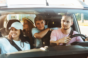 group of friends in car. road trip concept. summer vacation