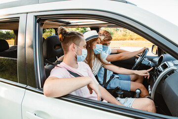 group of people riding in car with medical mask