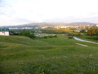 Fototapeta na wymiar Grass, valley, horizon. View of the city of Kislovodsk