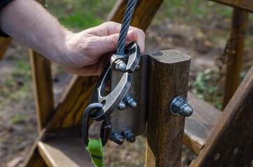 close-up of a man's hand with a safety harness. Extreme vacation. Rope park