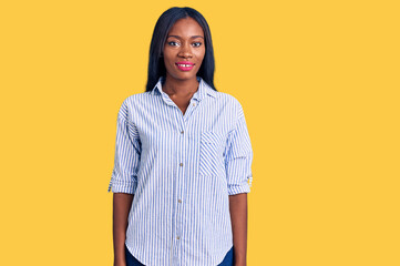 Young african american woman wearing casual clothes with a happy and cool smile on face. lucky person.