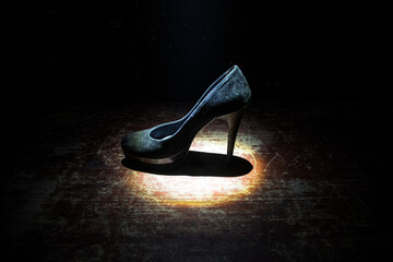 Silhouette of a high heel women shoes at dark. Women power or women domination concept.