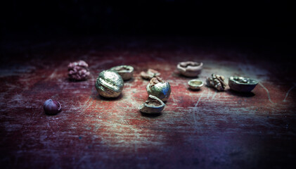 Still life with Walnut kernels and whole walnuts on rustic old wooden table. Creative table decoration.