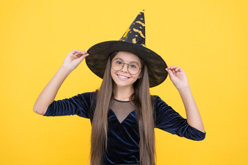 happy witch child wear hat costume of wizard and glasses on halloween party, happy halloween