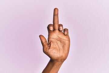 Arm and hand of black middle age woman over pink isolated background showing provocative and rude...