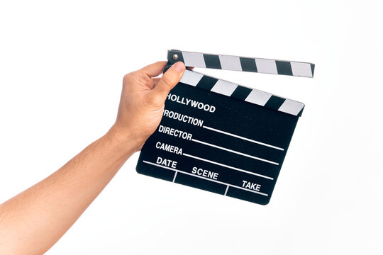 Hand of caucasian young filmmaker man holding clapboard over isolated white background