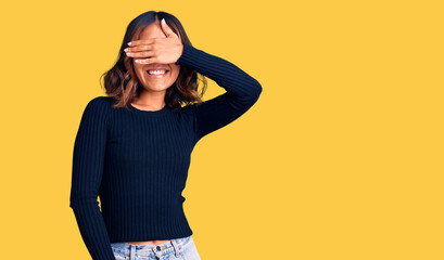 Young beautiful mixed race woman wearing casual clothes smiling and laughing with hand on face covering eyes for surprise. blind concept.