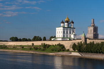 Fototapeta na wymiar Pskov Kremlin view. Towers, wall and Trinity cathedral on background. Pskov, Russia