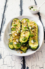 Slices of grilled zucchini with walnuts, soft cheese and greans close up