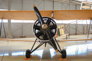 Old propeller plane in a hangar