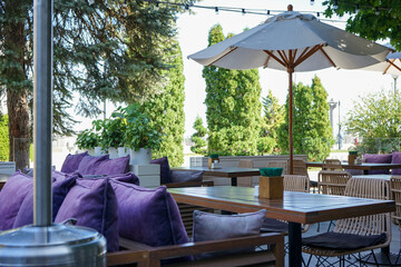 outdoor cafe terrace with umbrellas in summer without people