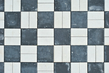 Cobblestone texture. The sidewalk tile is evenly folded. Multicolored cobblestones close up.