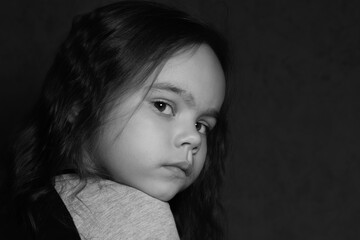 Black-and-white photo of a girl looking half-turned into the distance
