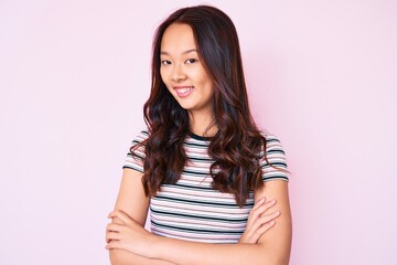 Fototapeta premium Young beautiful chinese girl wearing casual clothes happy face smiling with crossed arms looking at the camera. positive person.