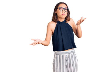 Young beautiful chinese girl wearing casual clothes and glasses clueless and confused expression...