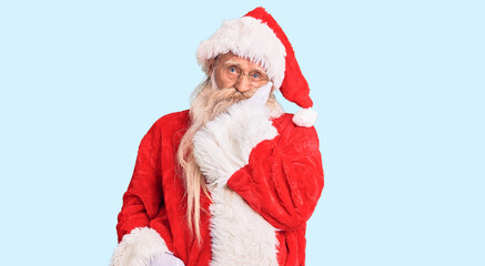 Old senior man with grey hair and long beard wearing traditional santa claus costume thinking looking tired and bored with depression problems with crossed arms.