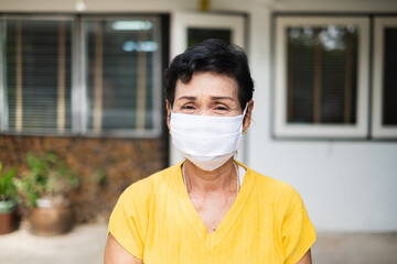 Senior old Asian woman, wearing face mask to protect coronavirus covid-19