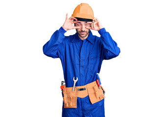 Young hispanic man wearing worker uniform trying to open eyes with fingers, sleepy and tired for morning fatigue