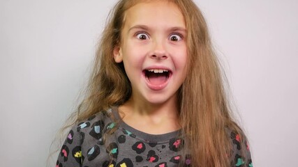 Cute girl with wide opened eyes shocked, joyful surprise.
