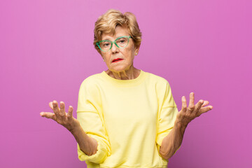 old pretty woman feeling clueless and confused, not sure which choice or option to pick, wondering