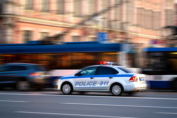 Fototapeta na wymiar police driving on the road, blurred background from speed
